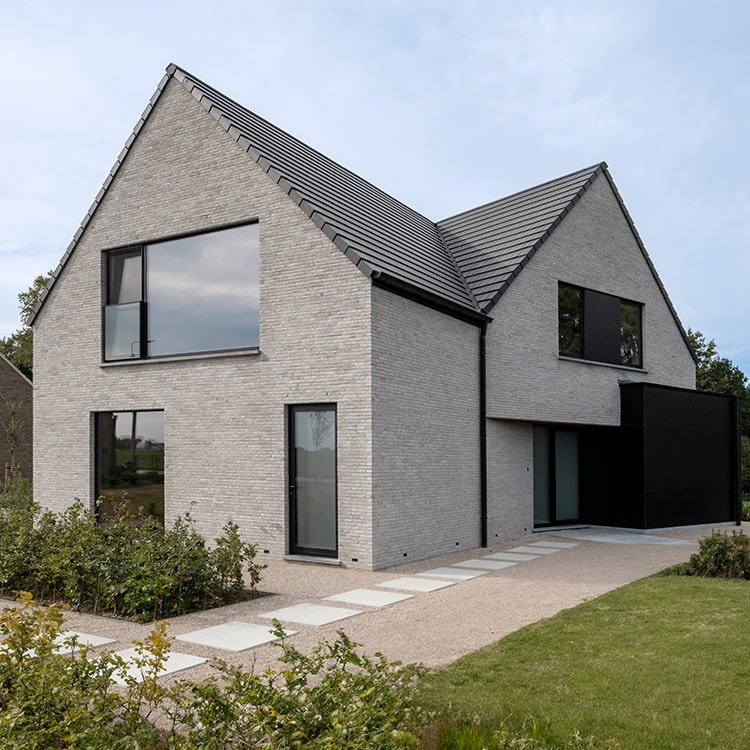 Maison contemporaine avec briques grises et toiture à deux versants